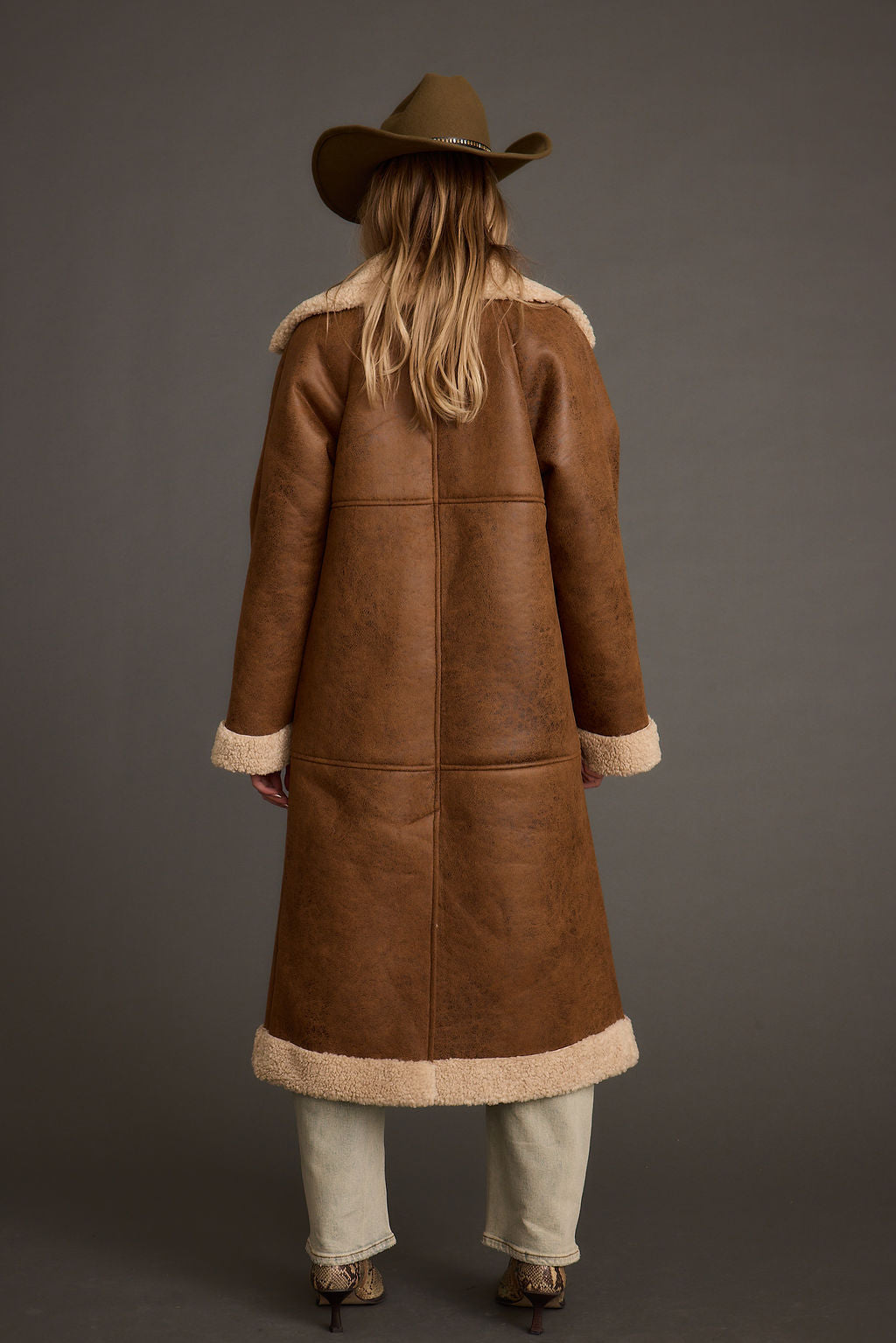 Back view of the brown jacket showing the silhouette and fit.